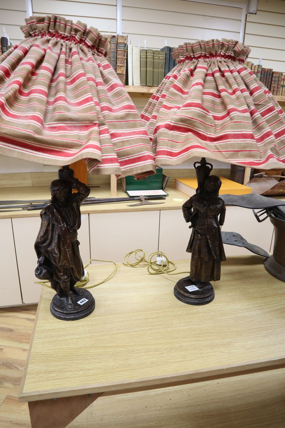 A pair of patinated spelter figural table lamps, male and female water carriers, 57cm excluding light fittings